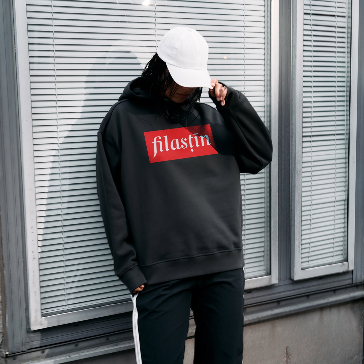 Red and white 'Filastin' on off-black oversized hoodie