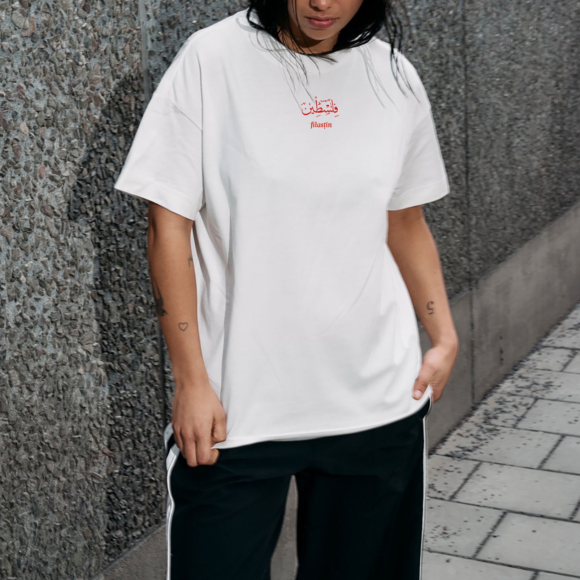 White Womans Oversized Thsirt with red Palestina print in arabic and latin